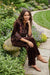 Woman wearing a leopard patterned 3/4 sleeve shirt with colorful embroideries from Johnny Was
