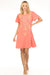 Woman wearing a coral embroidered dress with henley and flutter sleeves from Johnny Was