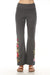 Woman wearing a gray flared high waist leggings with floral embroideries from Johnny Was