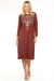 Woman wearing a chocolate brown dress with intricate embroidery and boat neck from Johnny Was