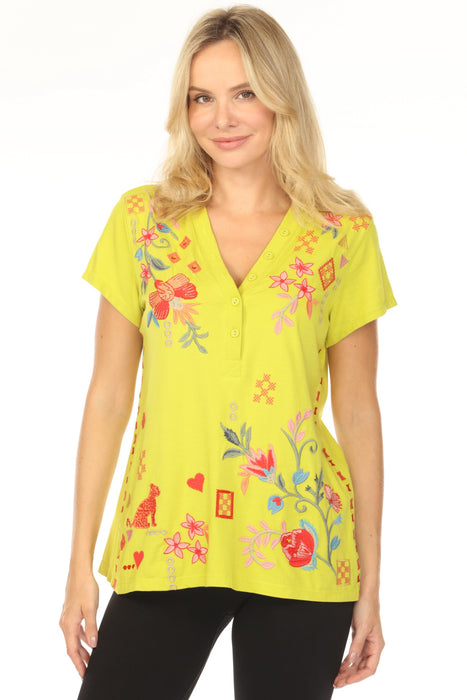 Woman wearing a citron tee with floral embroidery and buttoned v-neck from Johnny Was