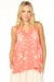 Woman wearing a coral tank top with v-neck and floral embroidery from Johnny Was