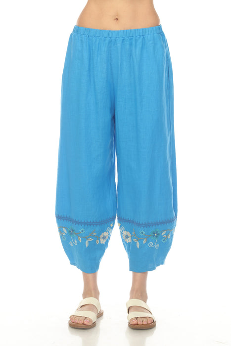 Woman wearing a blue linen pant with cropped barrel leg and embroidered hem from Johnny Was