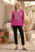 Woman wearing a violet long sleeve top with floral embroidery and split v-neck from Johnny Was