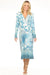 Woman wearing a blue floral midi dress with button v-neck and long sleeves from Johnny Was