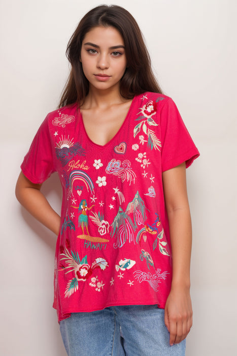 Woman wearing a pink t-shirt with colorful embroideries at the front from Johnny Was