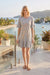 Woman wearing a JWLA knit shift dress with ruffle sleeves and tonal floral butterfly embroidery, styled for casual chic outings, travel, brunch, or boho everyday wear.