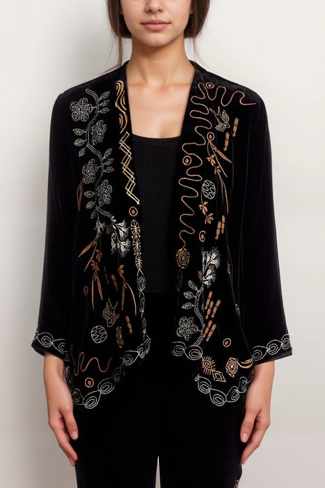 Woman wearing a black velvet bolero jacket with open front and embroidery from Johnny Was