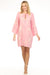 Woman wearing a pink dress with floral embroidery and kimono sleeves from Johnny Was