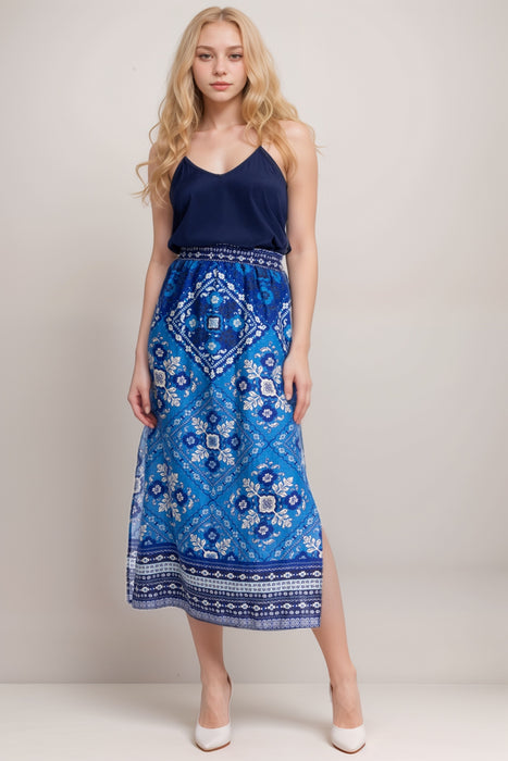 Woman wearing a blue tile-like patterned linen midi skirt with side high slit