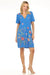 Woman wearing a blue floral embroidered dress with v-neck and buttons from Johnny Was