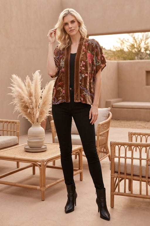 Woman wearing a floral embroidered open front velvet kimono from Johnny Was