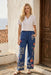 Woman wearing a blue floral embroidered wide leg cargo pants from Johnny Was