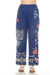 Woman wearing a blue floral embroidered wide leg cargo pants from Johnny Was