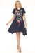 Woman wearing a blue floral embroidered cotton dress with handkerchief hem from Johnny Was