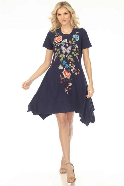 Woman wearing a blue floral embroidered cotton dress with handkerchief hem from Johnny Was