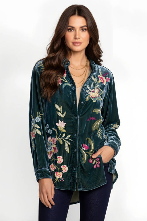 Woman wearing a dark green velvet oversized shirt with floral embroidery from Johnny Was
