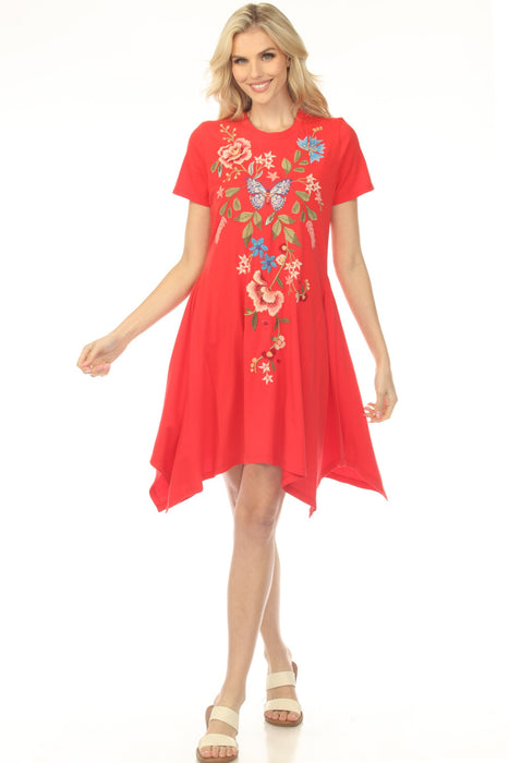 Woman wearing a red floral embroidered cotton dress with handkerchief hem from Johnny Was