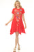 Woman wearing a red floral embroidered cotton dress with handkerchief hem from Johnny Was