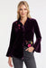 Woman wearing a purple velvet shirt with floral embroidery and flounce cuff sleeves from Johnny Was