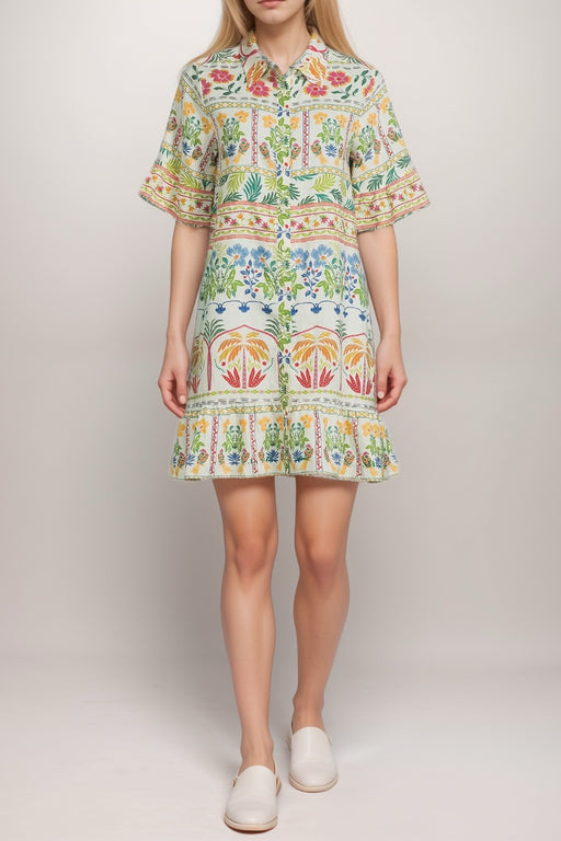 Woman wearing a colorful patterned shirt with flounce cuffs and hem from Johnny Was