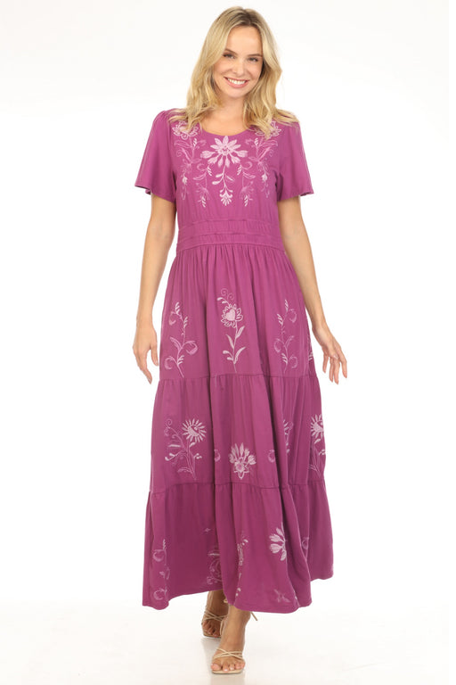 Woman wearing a violet maxi dress with floral embroidery and smocked waist from Johnny Was