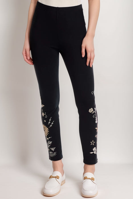 Woman wearing a black legging with floral embroidery