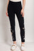 Woman wearing a black legging with floral embroidery