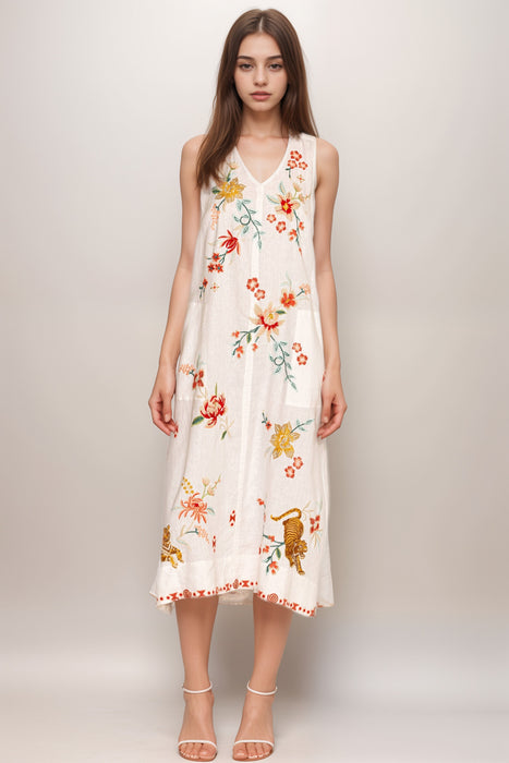 Woman wearing a white linen tank dress with floral embroideries and v-neck from Johnny Was