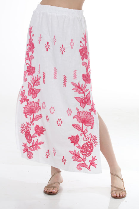 Woman wearing a white floral embroidered maxi skirt from Johnny Was