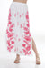 Woman wearing a white floral embroidered maxi skirt from Johnny Was