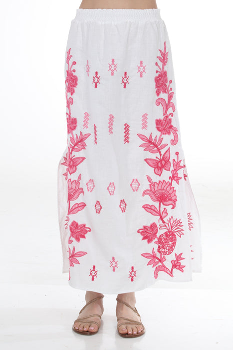 Woman wearing a white floral embroidered maxi skirt from Johnny Was