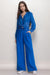 Woman wearing a blue wide leg pant with front pleat and front pockets from Johnny Was