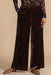 Woman wearing brown velvet wide leg pants with leopard pattern and side pockets from Johnny Was