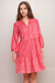 Woman wearing a pink dress with tonal embroideries and 3/4 puff sleeves