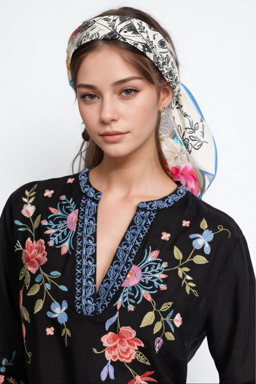 Woman wearing a white, cotton, floral head scarf from Johnny Was