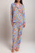Woman wearing a colorful floral-printed matching pajama top and pant from Johnny Was