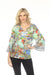 Woman wearing a colorful scenic patterned top with split v-neck tie and 3/4 sleeves from Johnny Was
