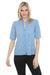 Woman wearing a light blue button front top with intricate tonal embroidery and short sleeves from Johnny Was