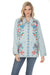 A woman modeling a light-wash denim jacket with colorful floral and paisley embroidery on the front, paired with blue jeans against a plain white background.