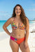 Woman wearing a colorful floral printed hipster bikini bottom from Johnny Was
