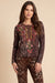 Woman wearing leopard printed henley top with colorful florals and long sleeves from Johnny Was