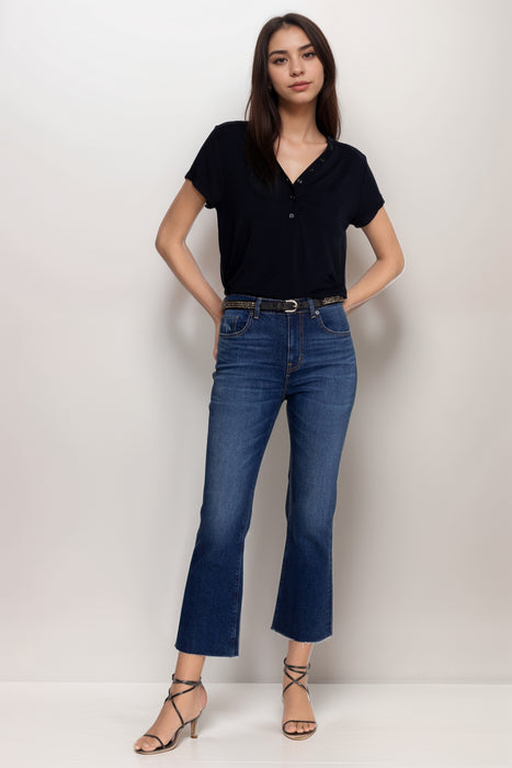 Woman wearing a blue baby boot jeans from Johnny Was