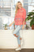 Woman wearing a light blue skinny denim jean with floral embroidery and crop frayed hem from Johnny Was
