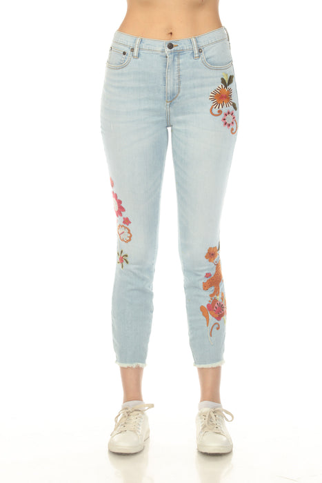 Woman wearing a light blue skinny denim jean with floral embroidery and crop frayed hem from Johnny Was