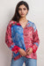 Woman wearing a scarf mix printed silk tunic with long sleeves