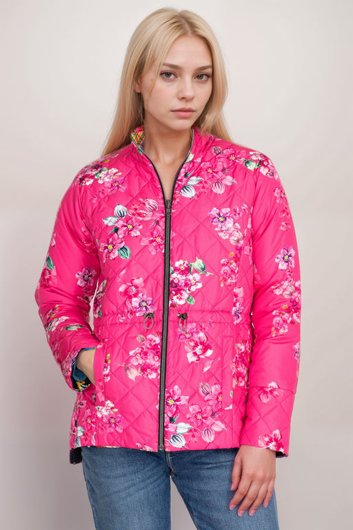 Woman wearing a pink quilted jacket with floral print and zip front closure from Johnny Was