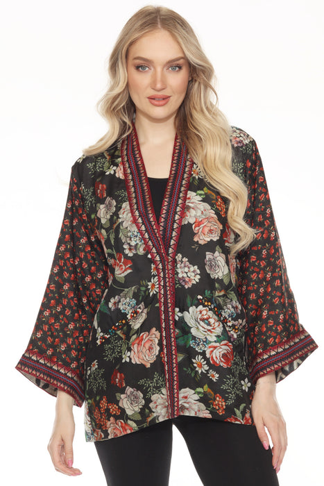 Woman wearing a floral printed silk kimono with embroidered edges