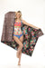 Woman holding a reversible leopard and floral patterned large beach towel from Johnny Was
