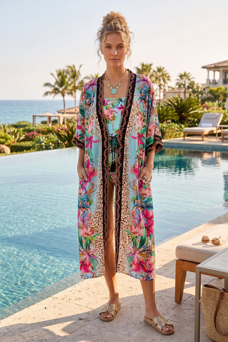 Woman in a colorful long kimono with side pockets and tassel front ties from Johnny Was